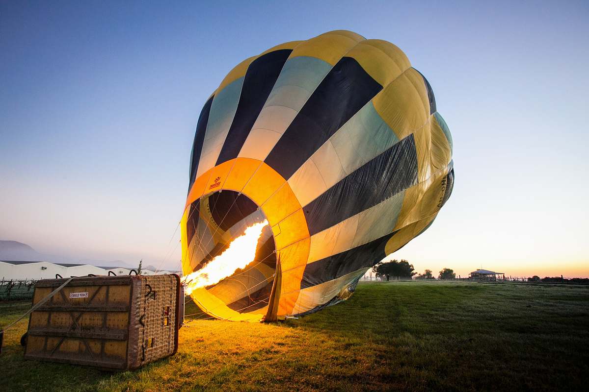 fire yellow and blue hot air balloon at daytime sunrise